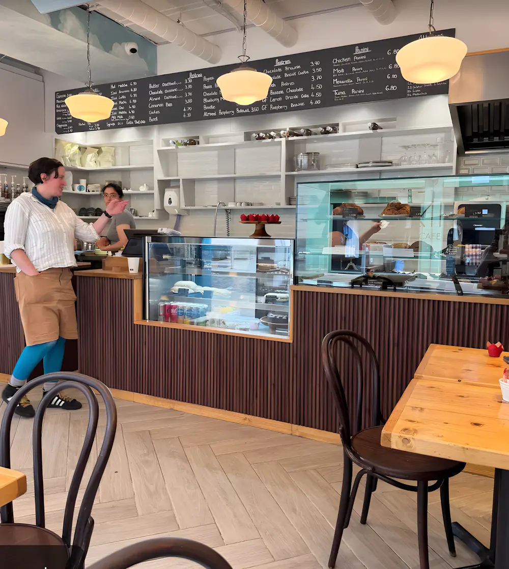 The Rumi counter: pendant lamps, the chalkboard menu and the pastry case