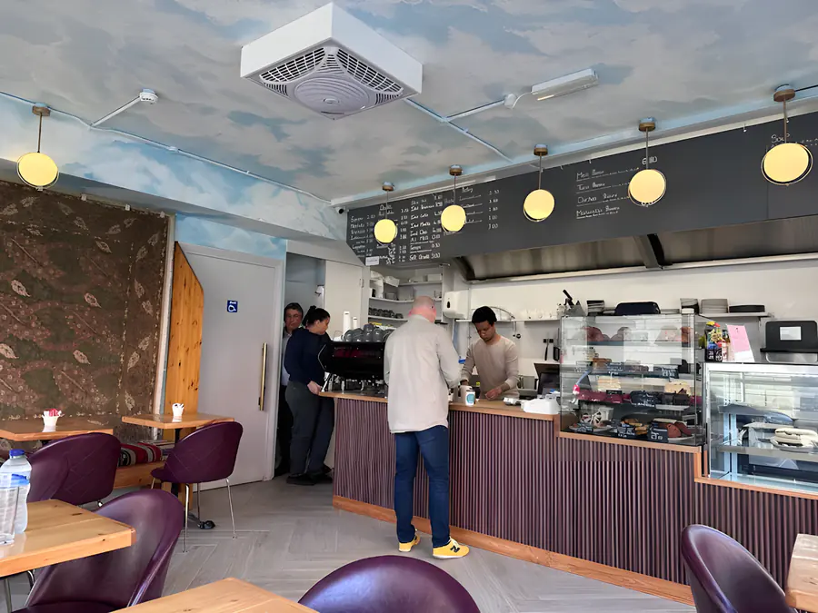 Inside Rumi: the counter, the cloud-painted ceiling and the café tables